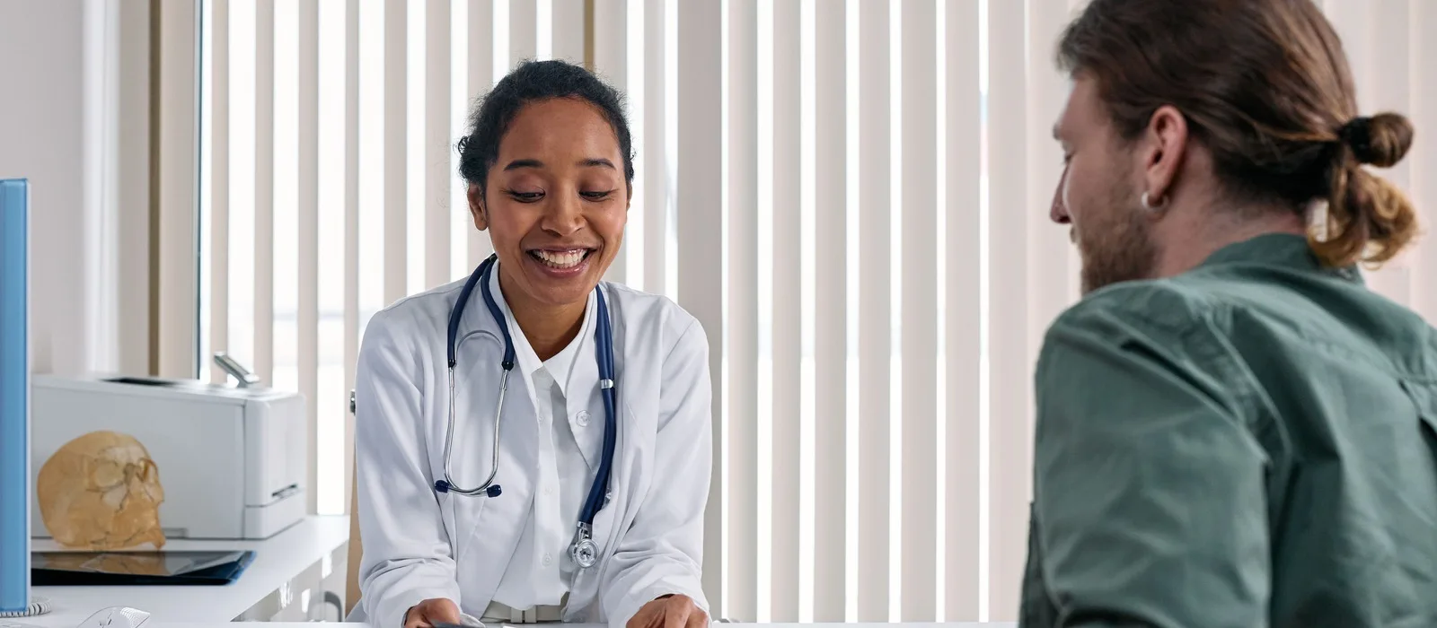 Smiling doctor consulting a patient in a bright clinic.