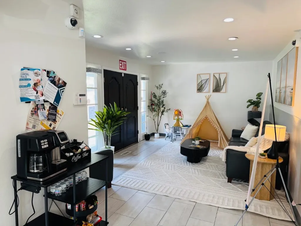 Welcome lounge with coffee bar, soft seating, and a children's play corner.